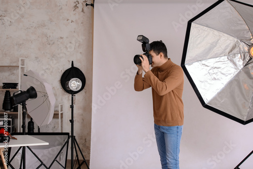 Young male photographer wit...