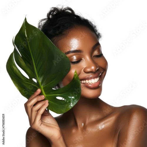 Beautiful African American young woman happy smile in the studio holds green tropical leaf in hands and covers a part of her face, Fashion beauty, make-up, cosmetics, isolated on white background, png