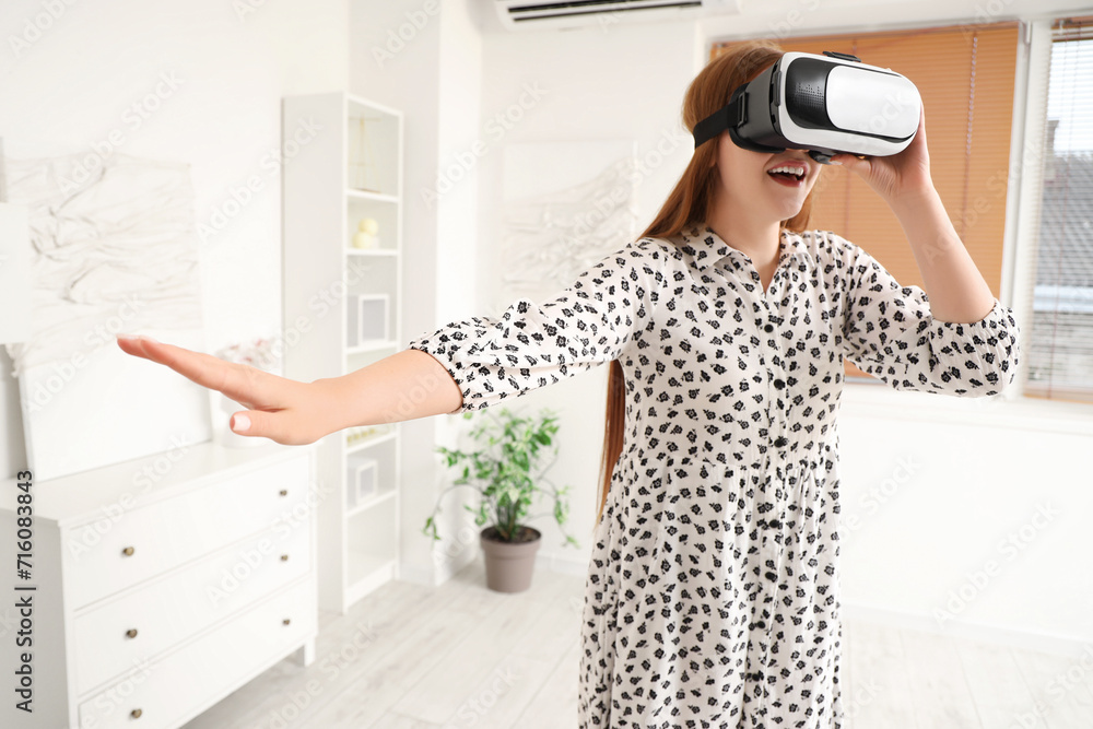Young woman using VR glasses on her day off at home Young woman using VR glasses on her day off at home