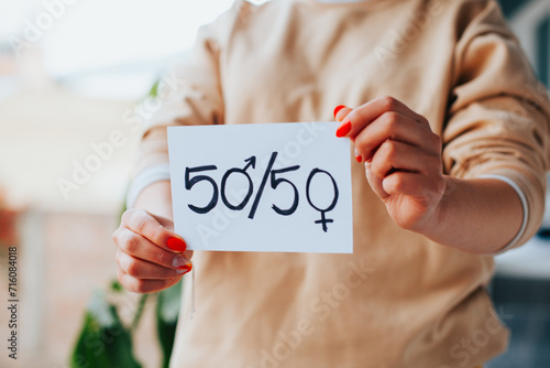 Photograph of incognito hands showing a message of equality.