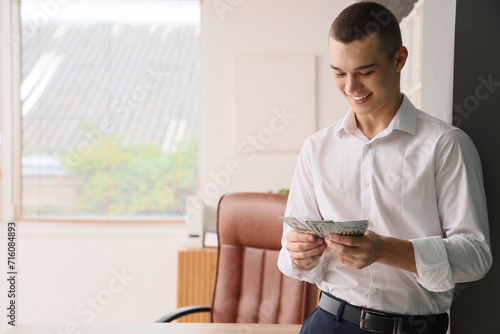Young man counting dollar b...