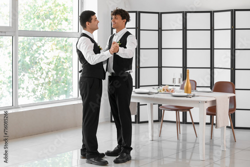 Happy gay couple dancing on...