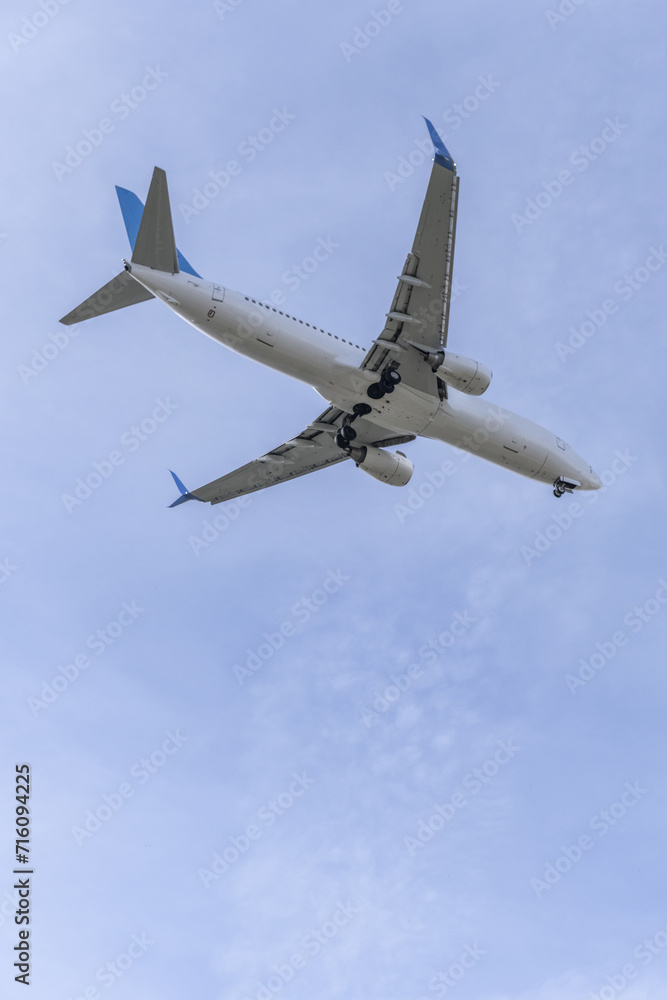 Views of the fuselage of a passenger plane approaching an airport runway Views of the fuselage of a passenger plane approaching an airport runway