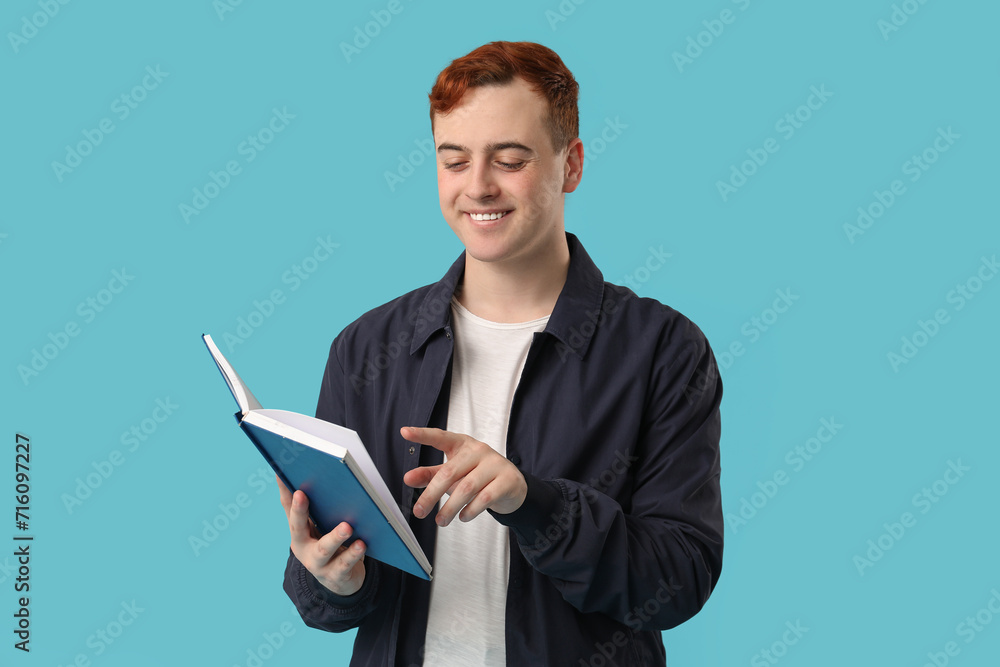 Smiling man reading book on color background Smiling man reading book on color background