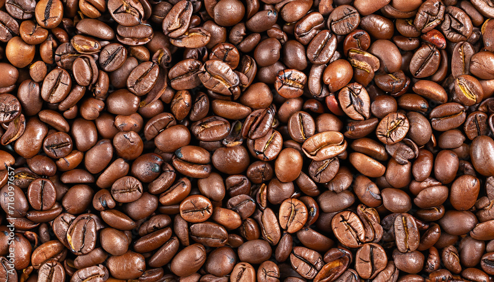 Fototapeta premium Top view of brown roasted coffee beans, can be use as background, copy space for text. High quality photo