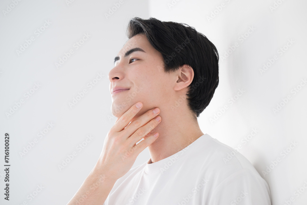 Asian (Japanese) man touching cheek Fresh image of hair removal and skin care Close-up For men's beauty and beauty Asian (Japanese) man touching cheek Fresh image of hair removal and skin care Close-up For men's beauty and beauty