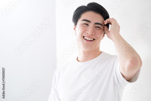 Asian (Japanese) man touching his hair Image of fresh hair removal and skin care For men's beauty and beauty