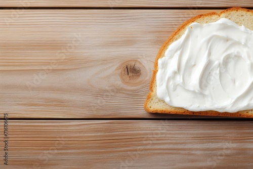 Top view of cream cheese on bread on wooden table photo