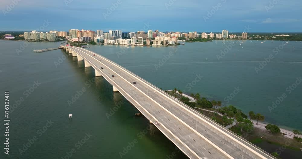 Sarasota city downtown at sunset. Ringling Bridge and expensive waterfront high-rise buildings in Florida. Urban travel destination in the USA. Sarasota city downtown at sunset. Ringling Bridge and expensive waterfront high-rise buildings in Florida. Urban travel destination in the USA.