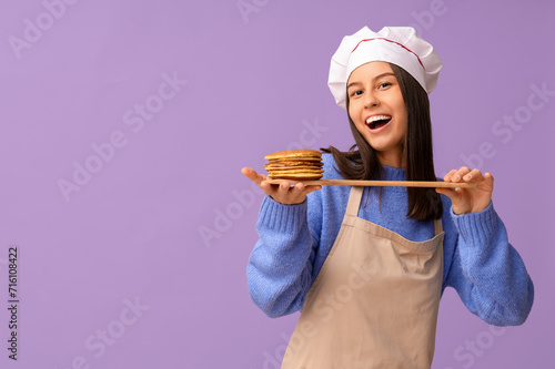 Happy female chef with tast...