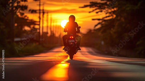 silhouette of a person riding motorcycle on sunset