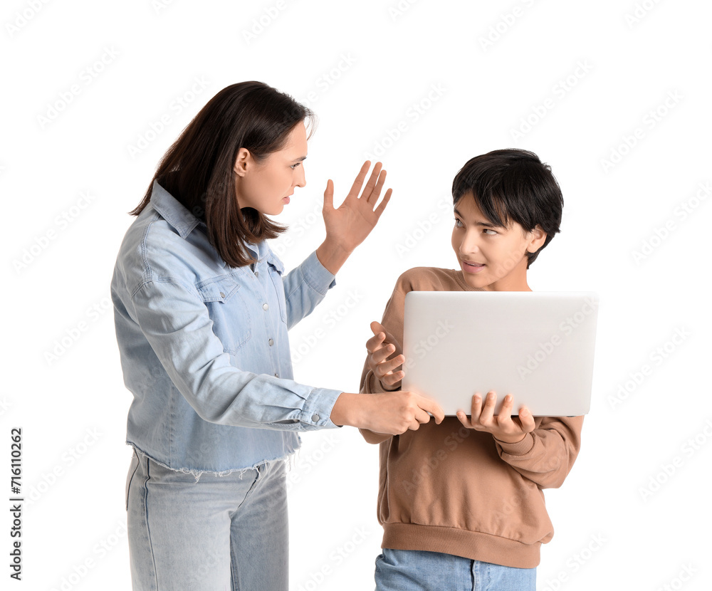 Teenage boy using laptop and his angry mother on white background. Family problem concept Teenage boy using laptop and his angry mother on white background. Family problem concept
