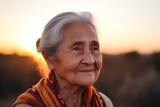 Portrait of a happy elderly woman on the background of the sunset