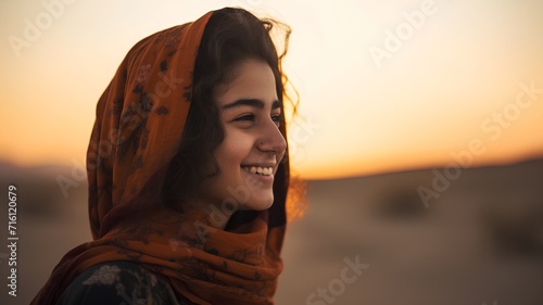 Young beautiful woman in the desert at sunset. Portrait of a girl