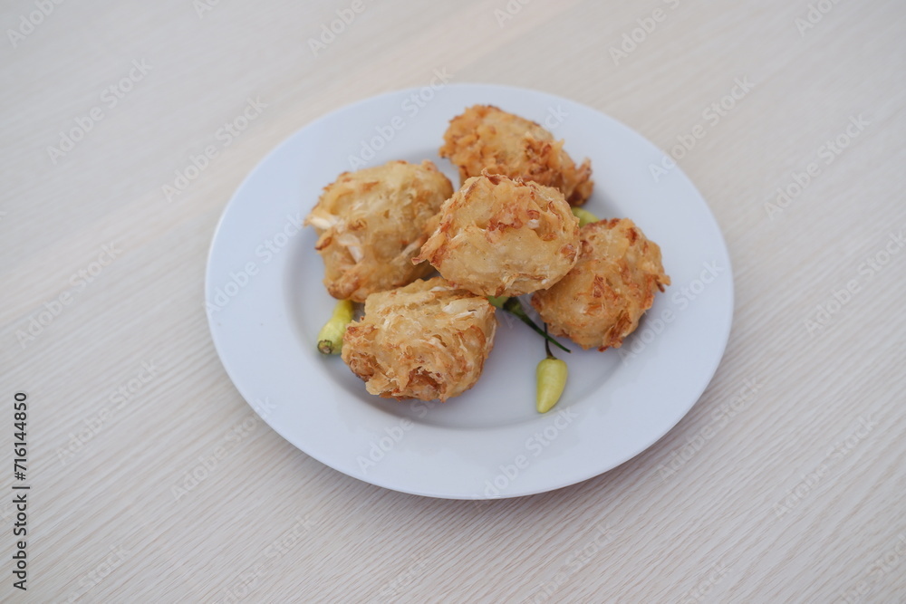 Bakwan sayur or vegetable fritter, Indonesian snack made from flour, cabbage, carrots and bean sprouts, served with chili Bakwan sayur or vegetable fritter, Indonesian snack made from flour, cabbage, carrots and bean sprouts, served with chili