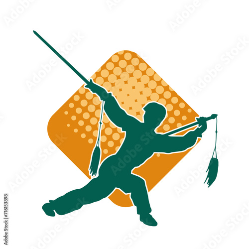 Silhouette of a kungfu or wushu martial art athlete in action pose. Silhouette of a male martial art person in pose with swords weapon.