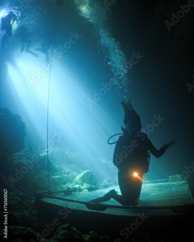 A Female Teen Scuba Diver Swims and Trains  at the Devil's Den Cave In Florida photo
