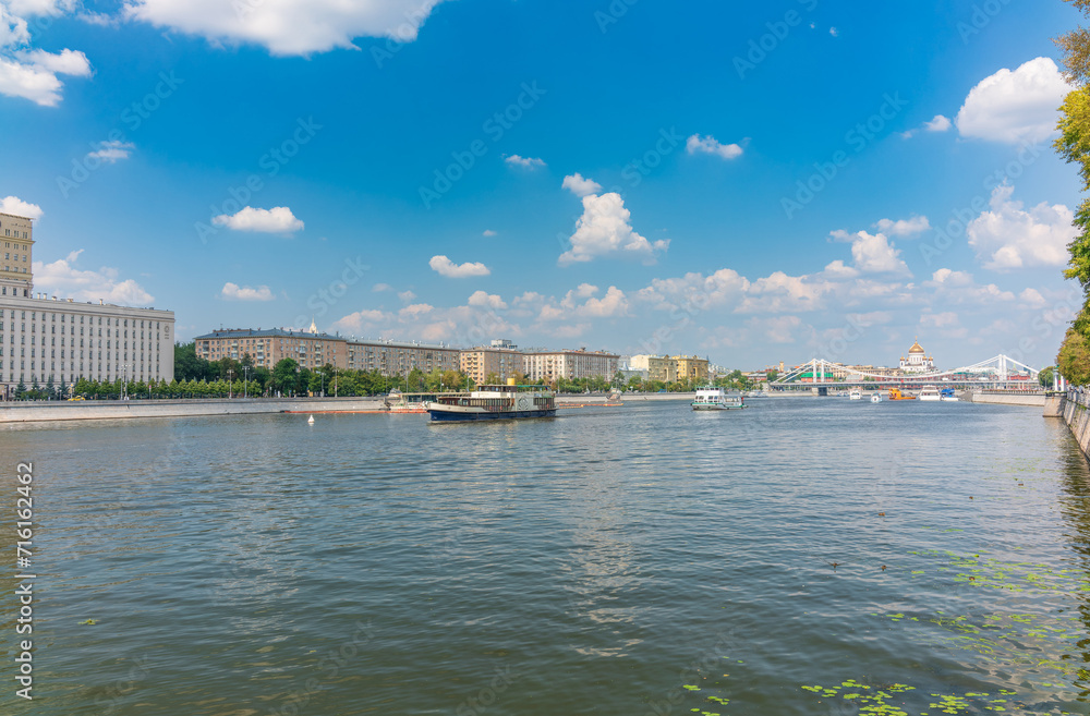 Fototapeta premium Cruise ship sails on the Moscow river in Moscow city center, popular place for walking.