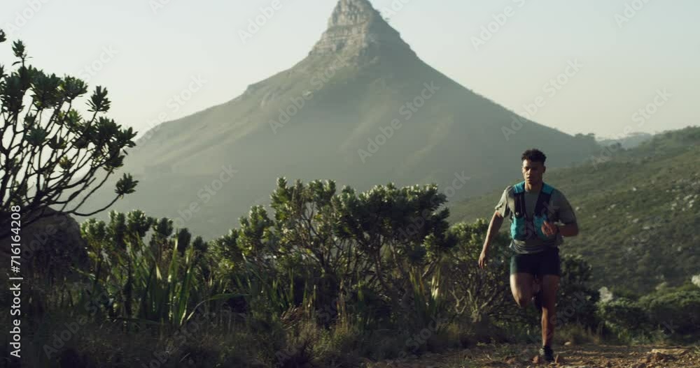 Man, running and hiking in nature on mountain, path and outdoor fitness ...