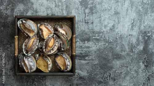 Fresh abalone on wooden tray