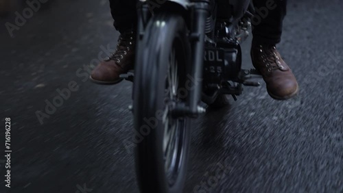 slow motion of a motorbike rider in the rain