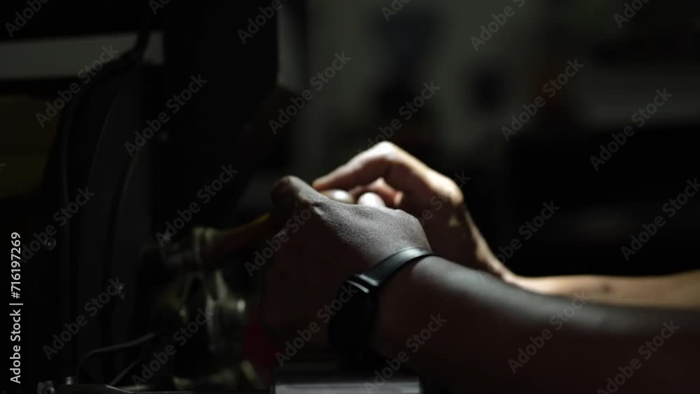 a person's hand holds a lever on the observation window of a coffee roaster machine a person's hand holds a lever on the observation window of a coffee roaster machine