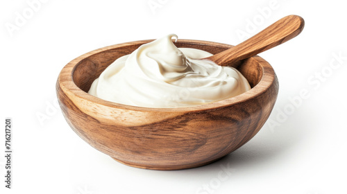 Wooden bowl filled with creamy yogurt, accompanied by spoon. Perfect for healthy eating or food-related projects