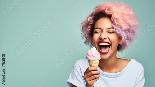 young afro American woman with vibrant pink hair holding ice cream photo