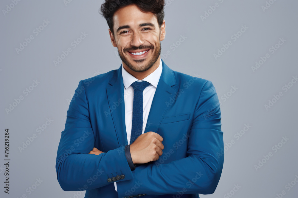 Picture of man wearing blue suit and tie with smile on his face. This image can be used for professional or business-related themes Picture of man wearing blue suit and tie with smile on his face. This image can be used for professional or business-related themes