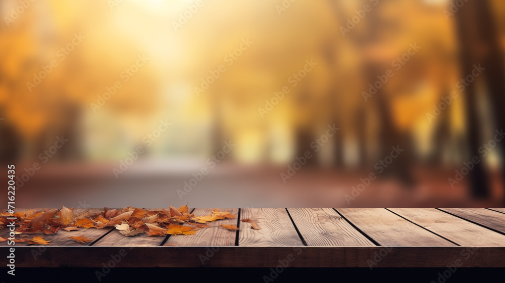 The empty wooden table top with blur background of autumn. Exuberant image.