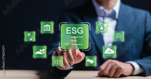 Businessman touch virtual screen of ESG icon for world sustainable environment concept. social business strategy, environment, business investment strategy. ESG environmental, social and governance.