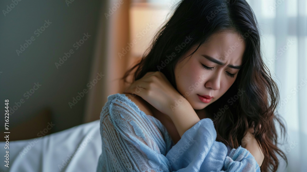 Woman with her arm around her neck. Can be used to depict relaxation, self-care, or stress relief Woman with her arm around her neck. Can be used to depict relaxation, self-care, or stress relief