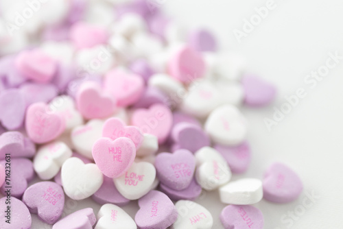 Background for Valentine's Day. Assorted pink, purple, white heart shaped candies with printed messages of love. Messages about kisses. Gift for Women's Day, March 8