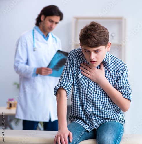 Male radiologist looking at boy's images