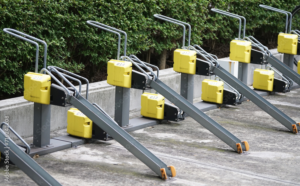 Stand between the wheels of an outdoor bicycle parking lot in Japan Stand between the wheels of an outdoor bicycle parking lot in Japan