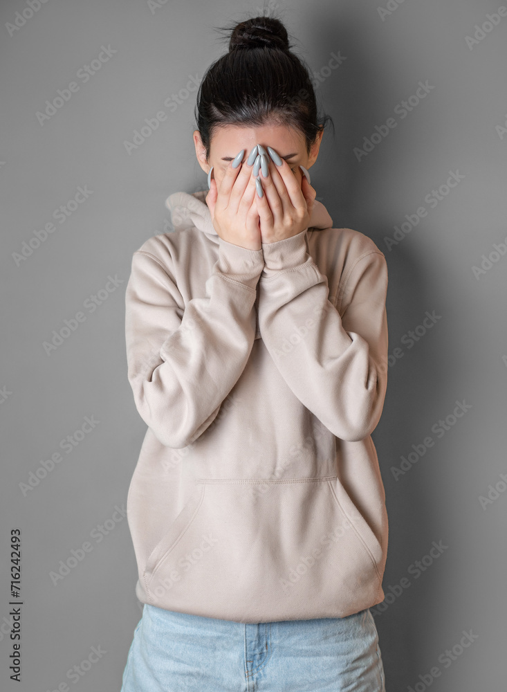 Pensive thoughtful young girl wearing sweatshirt with hood Pensive thoughtful young girl wearing sweatshirt with hood