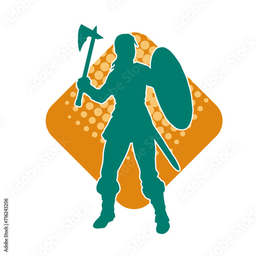 Silhouette of a sexy female warrior in battle armor carrying axe weapon and iron shield.