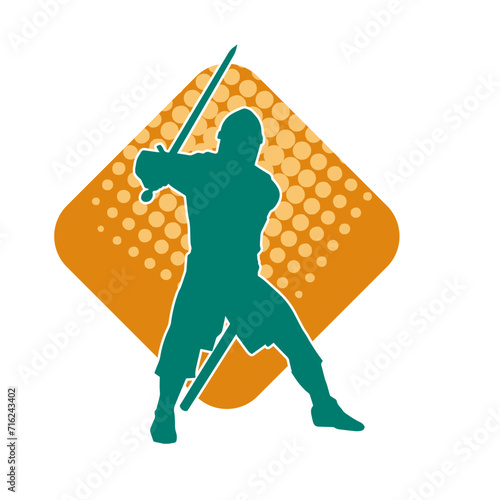 Silhouette of a male warrior wearing war armor suit in action pose using a sword weapon.