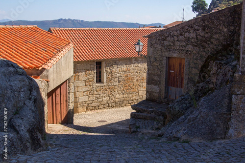 photo view of a shady street with stone houses in the village Monsanto in Portugal
