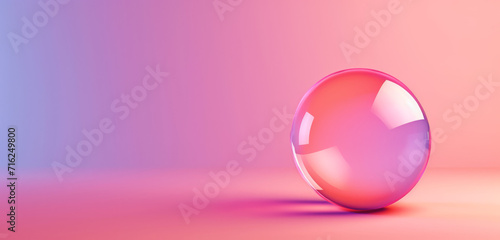 A shiny glass sphere on a gradient pastel background.