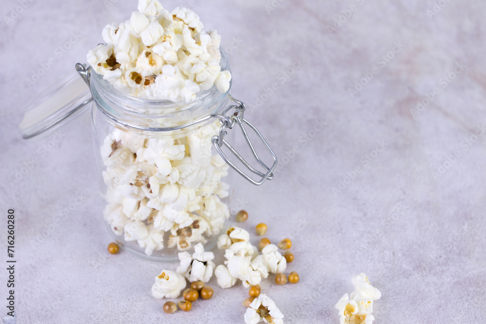 popcorn in glass jars, gray background, selective focus