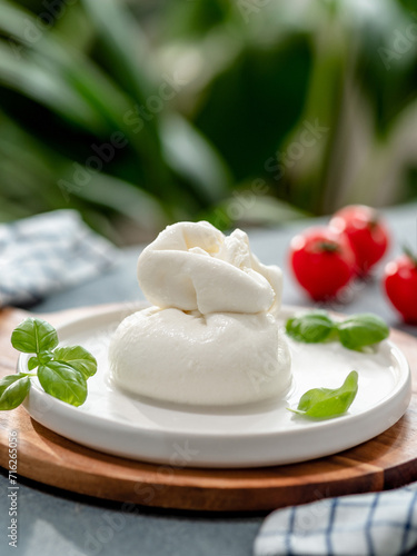 Burrata cheese on plate, copy space. Gray background