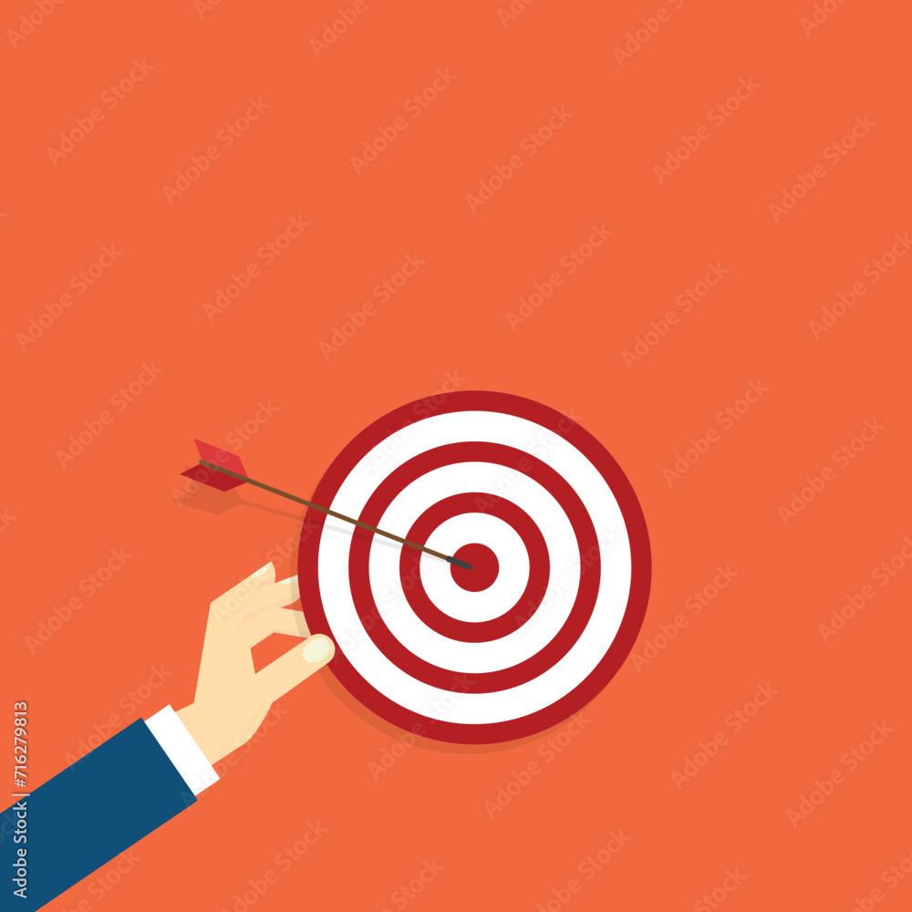 Hand holding a target, showing a goal. Red arrow hits the center. Business challenge failure and success concept. Hand holding a target, showing a goal. Red arrow hits the center. Business challenge failure and success concept.