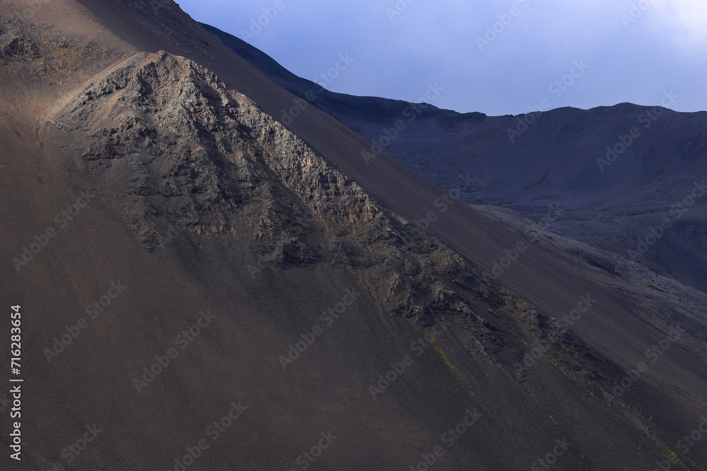 Fototapeta premium partially sunlit mountain side in Iceland