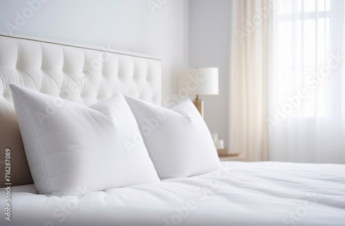 Clean bed. Light bedroom. Modern apartment interior. White sheet, soft pillow, blanket and bedside table. Home, hotel stylish design. Comfortable grey bedding set closeup. Spa resort ad. Rent business photo
