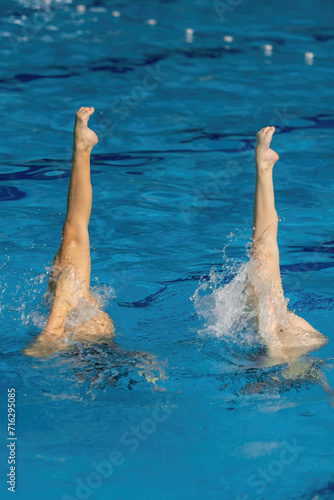 Synchronized swimming duet dance. Synchronized swimming duet enchants the pool with their graceful dance