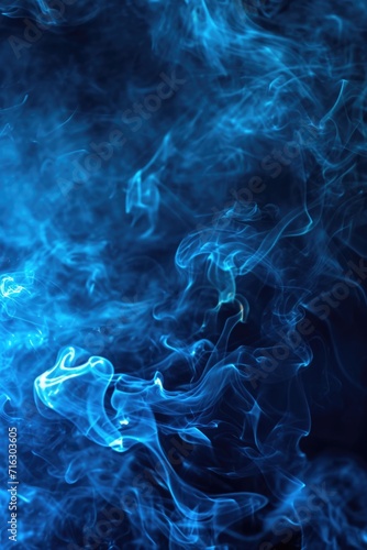 Close up shot of blue smoke on a black background. Perfect for adding a mysterious and ethereal touch to your designs