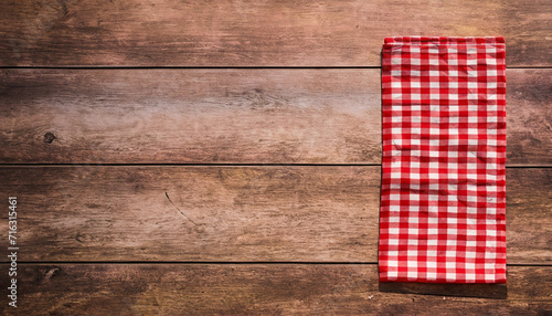 Red checkered napkin on a rustic wooden table with copy space for placing your text or product. Italian, homemade, traditional kitchen. High quality photo