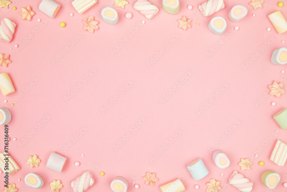 Cute pastel pink kawaii background with frame of sweet meringue and marshmallows . Flat lay, top view, copy space. Beautiful childlike design template
