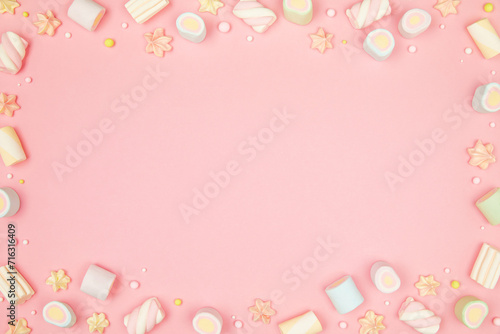 Cute pastel pink kawaii background with frame of sweet meringue and marshmallows . Flat lay, top view, copy space. Beautiful childlike design template © Aleksandra Konoplya